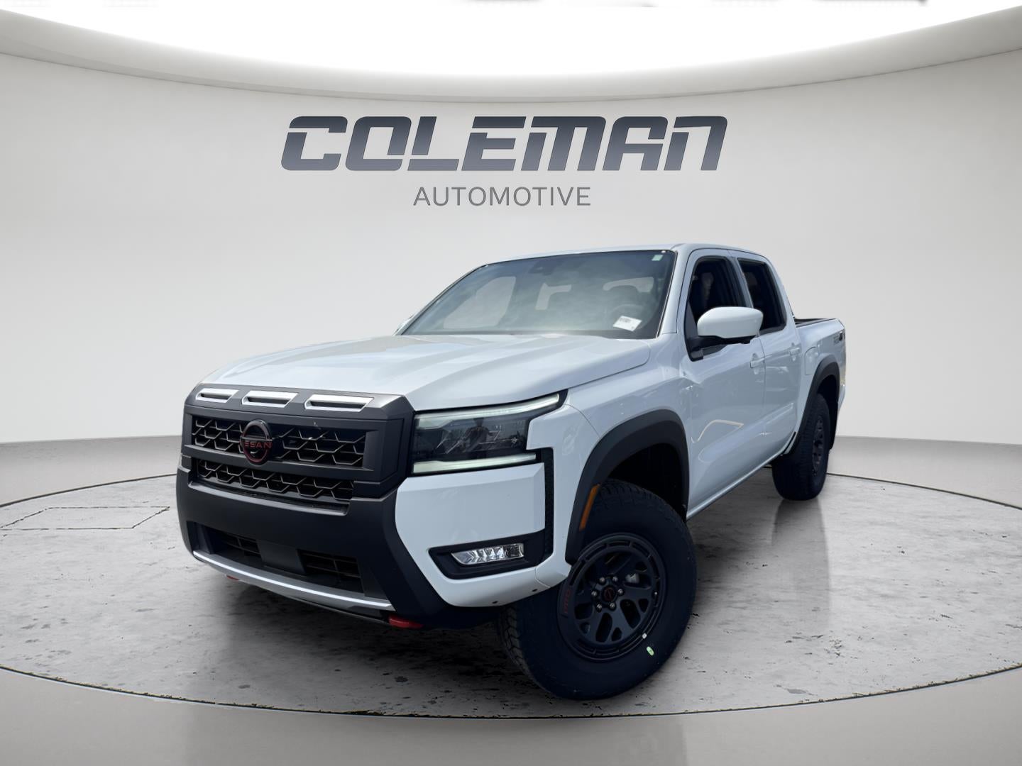 2026 Nissan Frontier Crew Cab PRO-4X in Glacier White — front three-quarter view